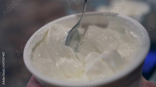 Stirring yogurt in slow motion. Shallow depth of field. photo