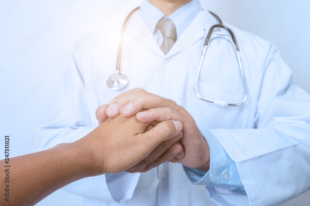 Hand of doctor reassuring his patient Hand of doctor reassuring his patient