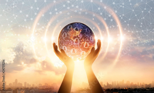 Hands holding earth and wave circle global structure network connection and data exchanges customers worldwide on sunset background. Innovation and inspiration. Networking and technology concept photo