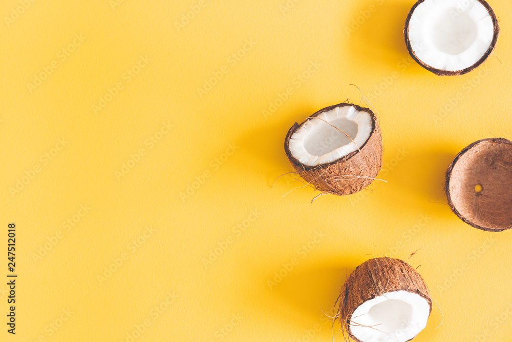 Summer composition. Coconut on yellow background. Summer concept. Flat lay, top view, copy space