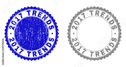 2017 TRENDS stamp seals with distress texture in blue and gray colors isolated on white background. Vector rubber imitation of 2017 TRENDS caption inside round rosette.