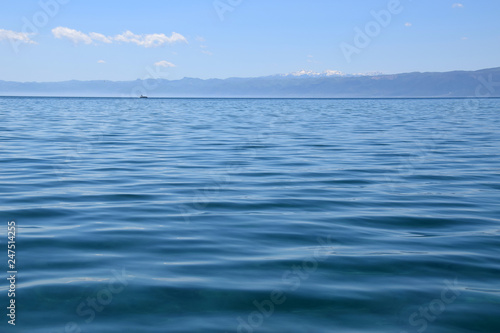 Wave on Ohrid Lake with mountain and ship background. Ohrid, Macedonia.