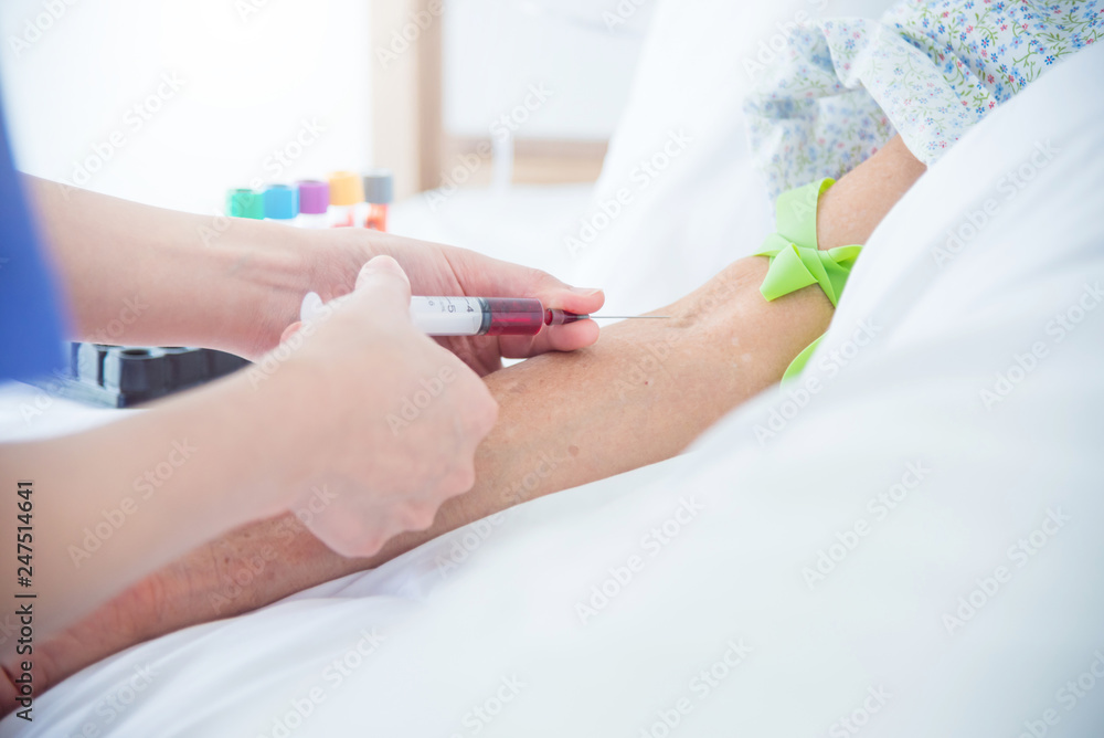 Nurse taking patient's blood sample for medical examination in hospital Nurse taking patient's blood sample for medical examination in hospital