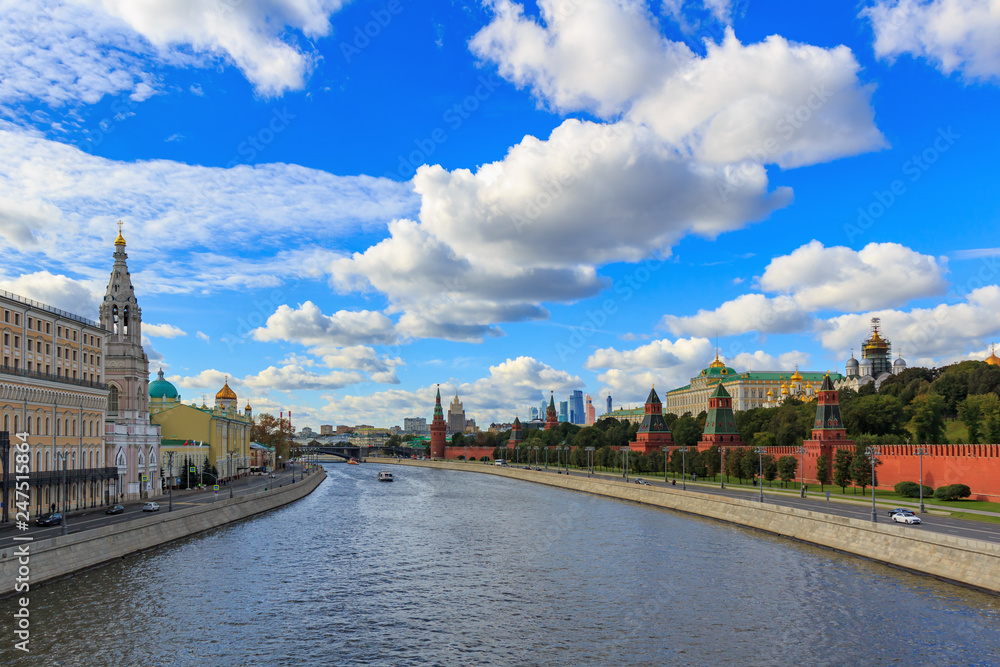 Panorama of Moskva river near Moscow Kremlin in sunny day against blue sky with white clouds