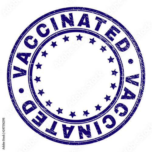 VACCINATED stamp seal imprint with distress texture. Designed with round shapes and stars. Blue vector rubber print of VACCINATED title with scratched texture.