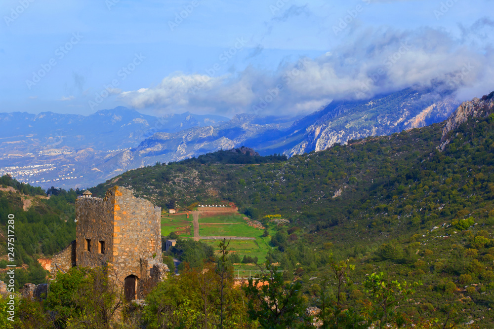 background view of the ruins of the castle of St. Illarion from above, and the panorama of the surrounding mountains, in the vicinity of Kyrenia, Northern Cyprus