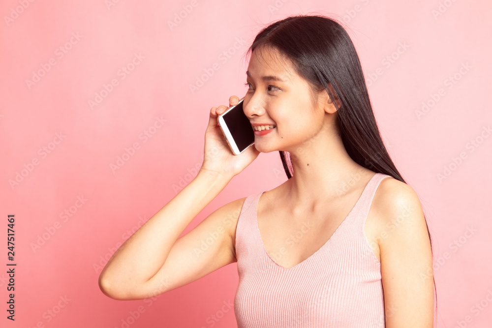 Young Asian woman talking with mobile phone. Young Asian woman talking with mobile phone.