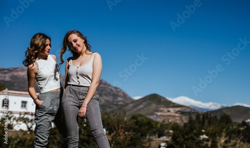 Two young girls enjoy the sun in spring