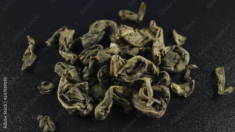 Detailed tea leaves close up on a dark background Detailed tea leaves close up on a dark background