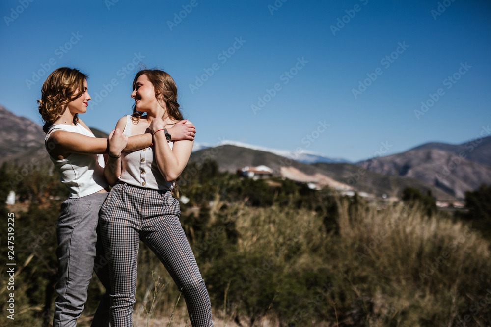 Two young girls enjoy the sun in spring