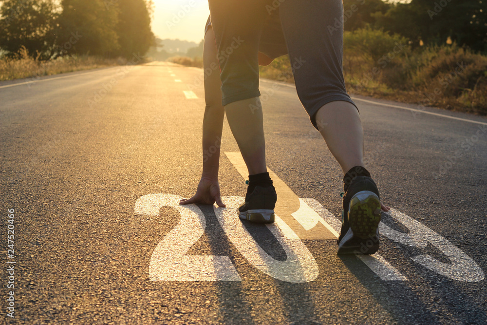 .Healthy way of life new year concept. goals and plans, Healthcare and medical. Woman in sports wear running start to goals new year 2019 on the road in sunset background. .Healthy way of life new year concept. goals and plans, Healthcare and medical. Woman in sports wear running start to goals new year 2019 on the road in sunset background.