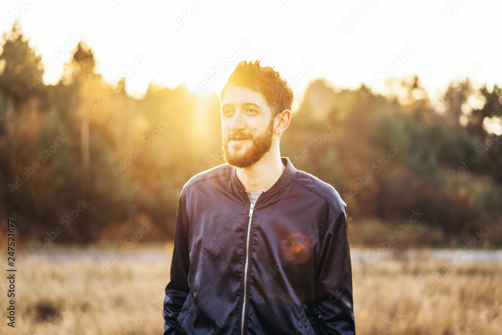 Happy young man with beard walking outdoor. Happy young man with beard walking outdoor.