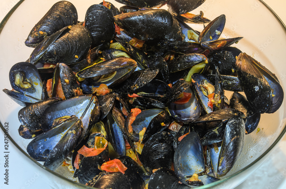 Boiled mussels with sauce in the plate Boiled mussels with sauce in the plate