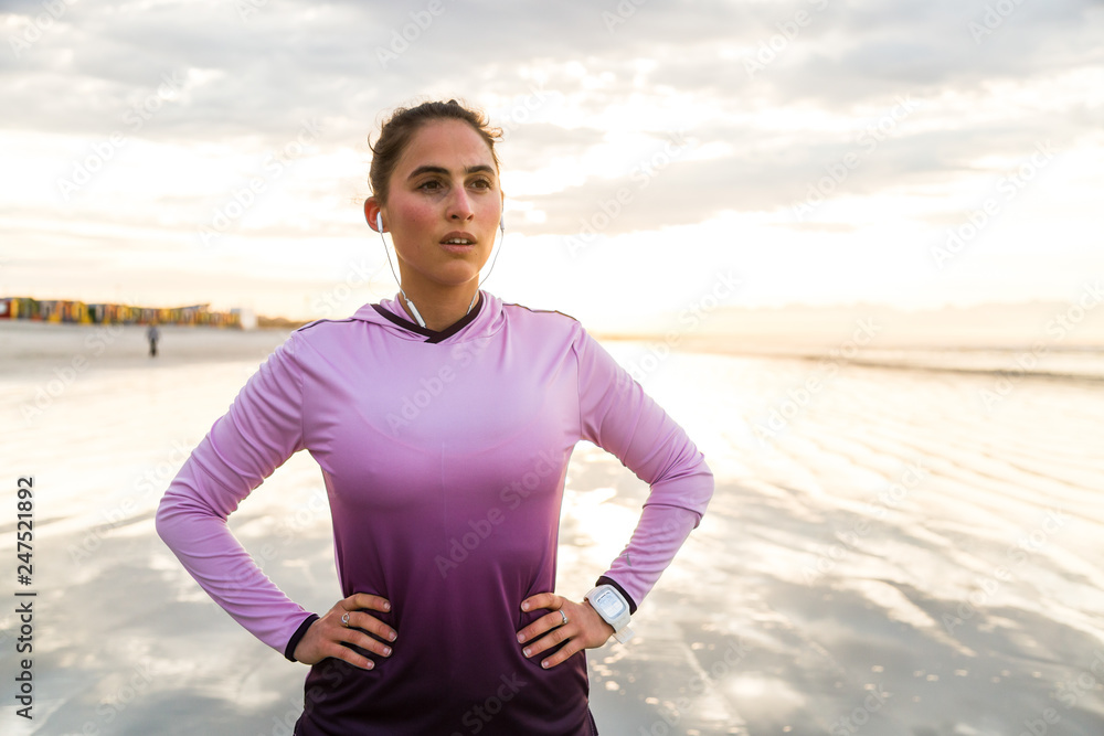 Female runner recovering after beach jog Female runner recovering after beach jog