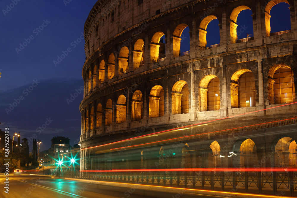 Colosseum at night with colorful blurred traffic lights. Rome, Italy. Rome landmark