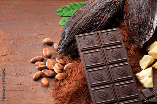 Chocolate bar pieces, cocoa butter and cocoa pods