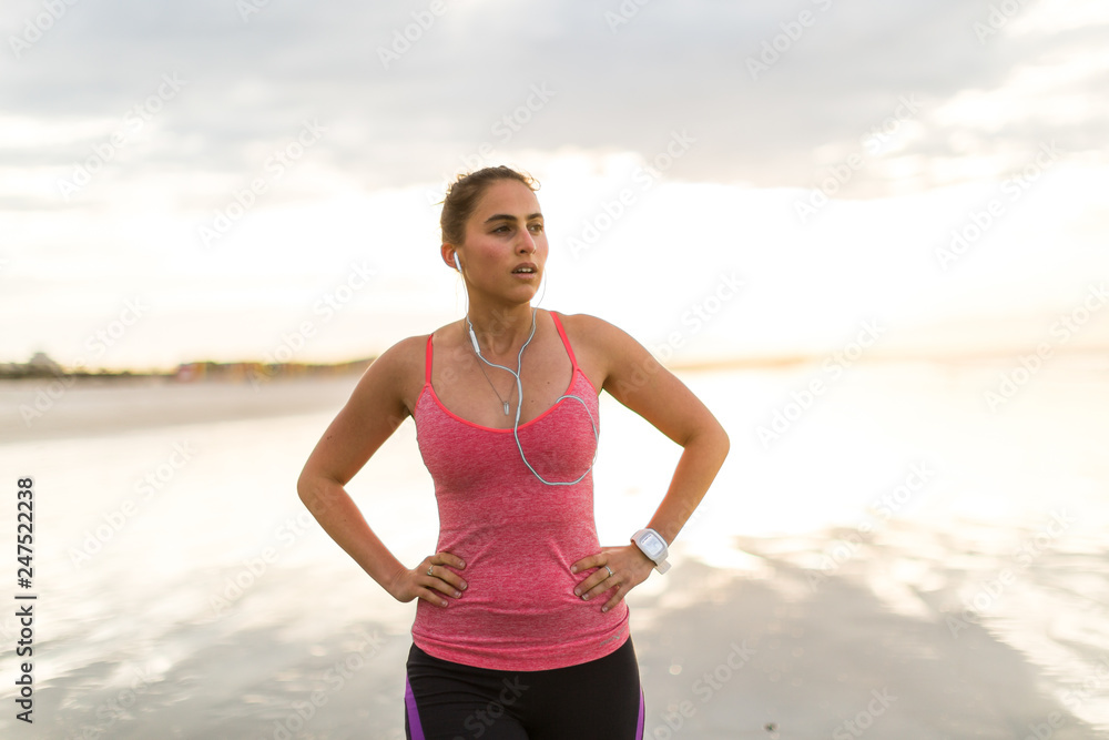 Female runner recovering after beach jog Female runner recovering after beach jog
