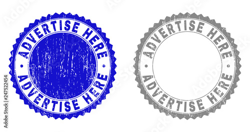 ADVERTISE HERE stamp seals with distress texture in blue and grey colors isolated on white background. Vector rubber imprint of ADVERTISE HERE text inside round rosette.