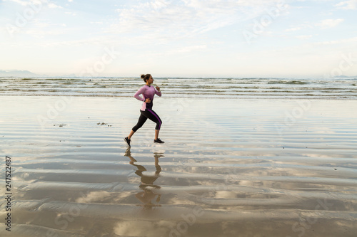 Young woman running on beach