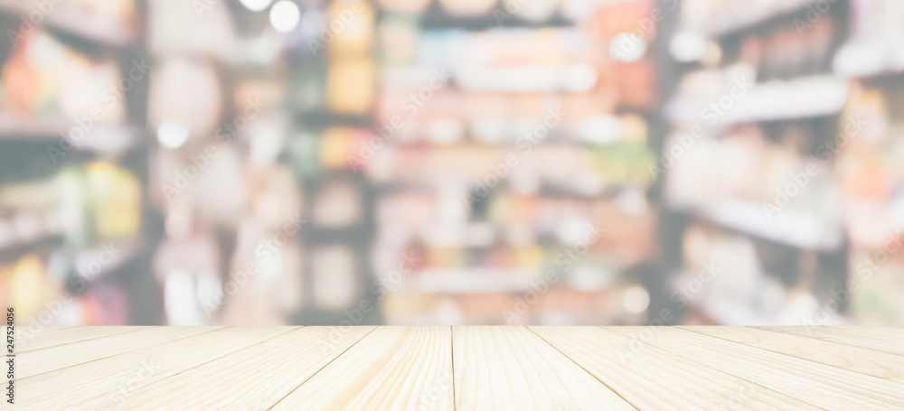 Wood table top with Abstract supermarket grocery store refrigerator blurred defocused background with bokeh light