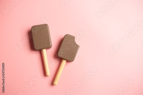 Ice cream chocolate on pink background, wooden toy of children