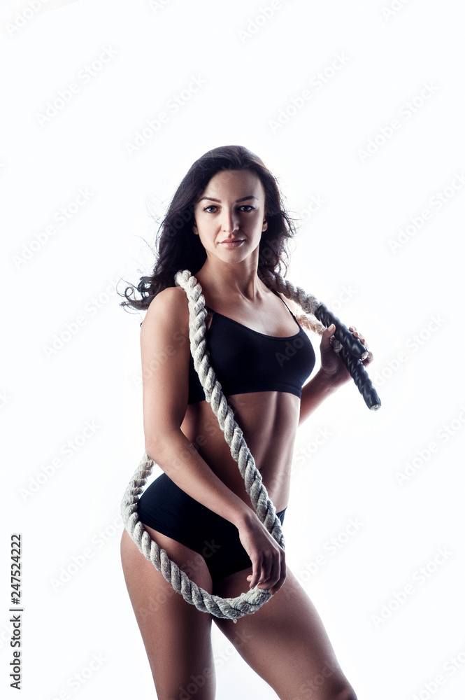 Young sporty and athletic woman with training ropes, isolated over white background Young sporty and athletic woman with training ropes, isolated over white background