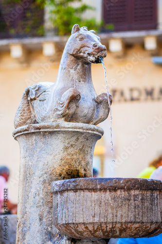 TAORMINA, ITALY - OCTOBER 16, 2014: Fountain on Piazza del Duomo in Taormina city in Sicily. Baroque fountain with two centaurs and bust of an angel