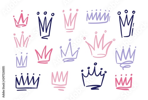 Set of drawings of doodle abatract crowns. Symbols of princess hand drawn with pink and purple freehand lines on white background. Vector illustration.