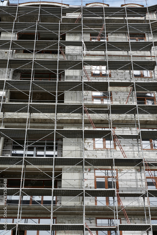 new building under construction, scaffolding and concrete