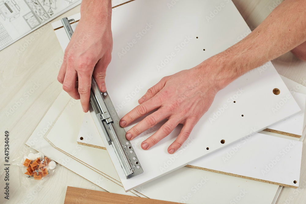 The furniture assembler joins together the two parts of the readyto