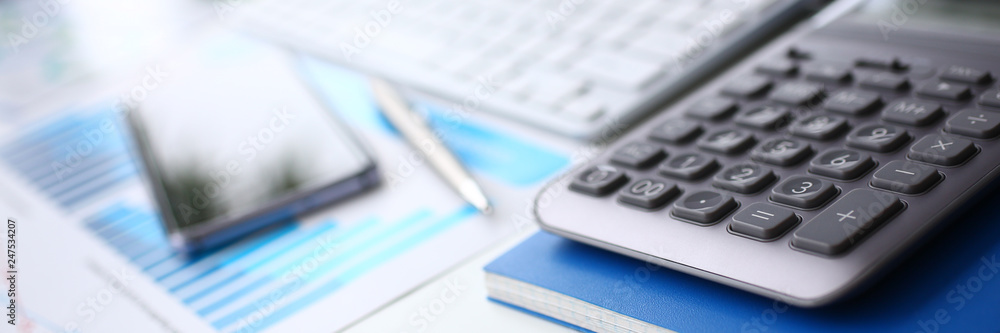 Silver calculator and financial statistics on clipboard Silver calculator and financial statistics on clipboard
