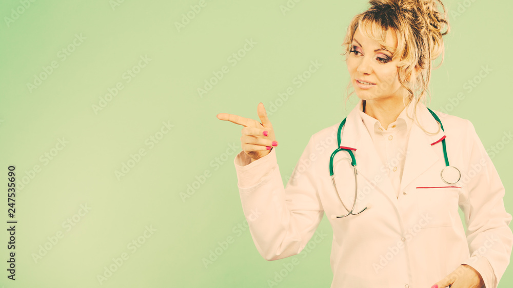 Female doctor showing copy space. Female doctor showing copy space.