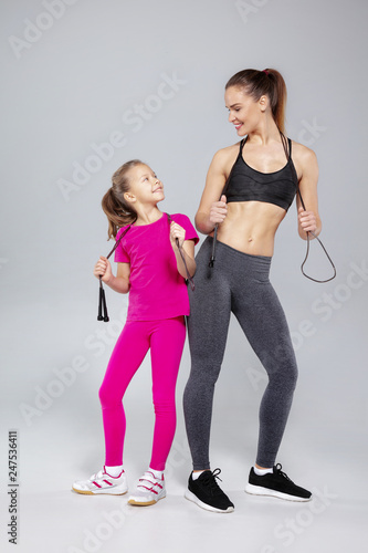 Beautiful woman and her daughter with jumping rope