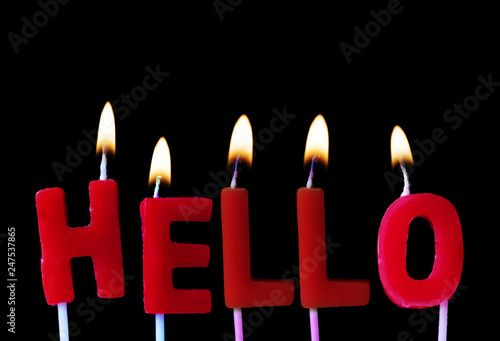Hello spellt out in red birthday candles against a black background