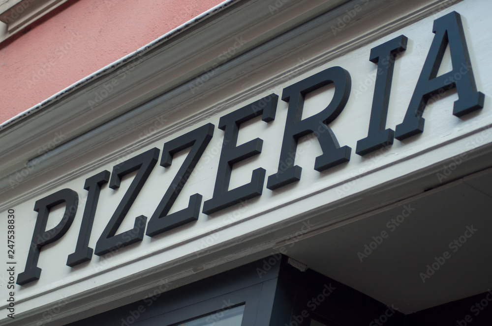 closeup of pizzeria sign on italian restaurant facade
