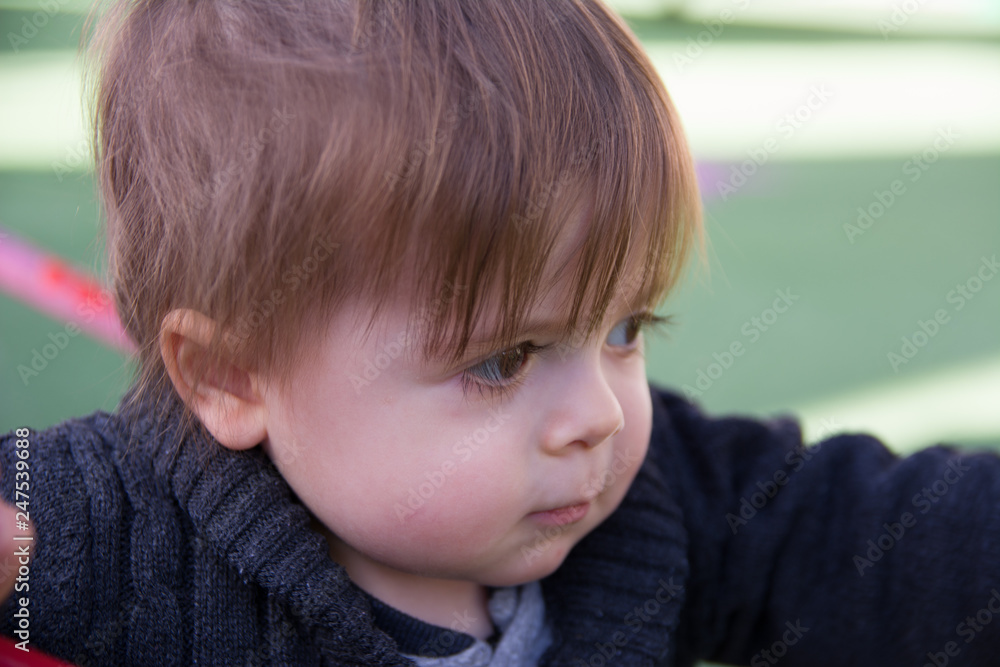Image of sweet baby boy, closeup portrait of child on playground Image of sweet baby boy, closeup portrait of child on playground