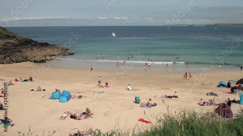 Holidaymakers on the beach at Porthgwidden beach, St Ives, Cornwall photo