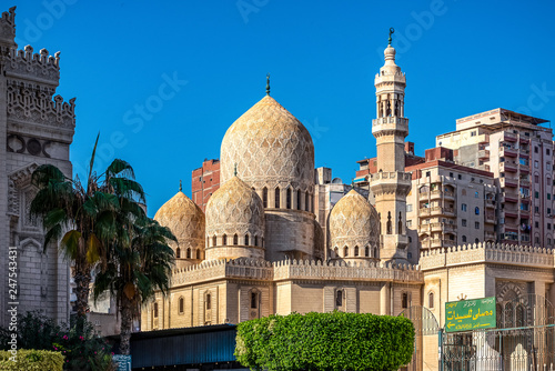 .18/11/2018 Alexandria, Egypt, Incredibly beautiful mosque Abo El Abass against blue sky and palm trees on a sunny day. photo