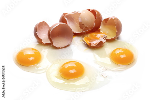 Broken eggs, eggshells with yolk isolated on white background