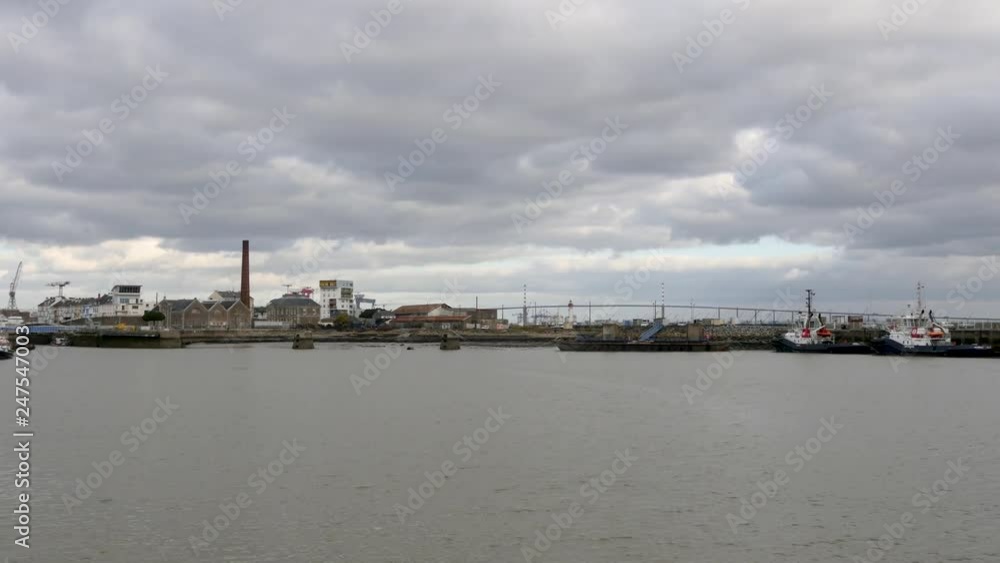Panorama of Saint-Nazaire, a city in western France, in the Loire Atlantique region. Cloudy sky. Filmed in winter. Big bridge in the background. Panorama of Saint-Nazaire, a city in western France, in the Loire Atlantique region. Cloudy sky. Filmed in winter. Big bridge in the background.