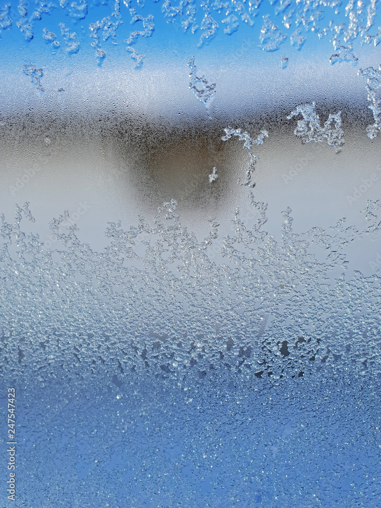 Icy water drops on glass