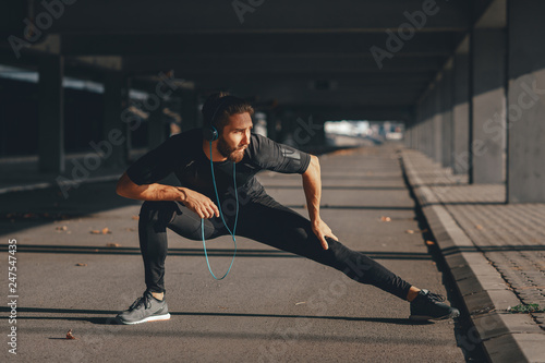 Young sports man stretching outdoors
