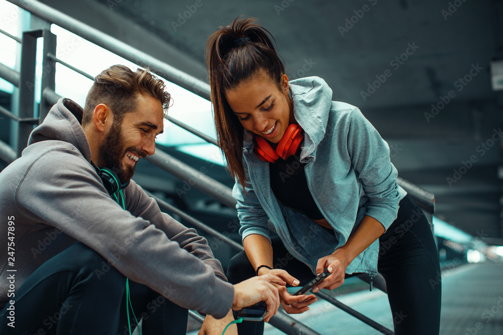 Young couple choosing music before running