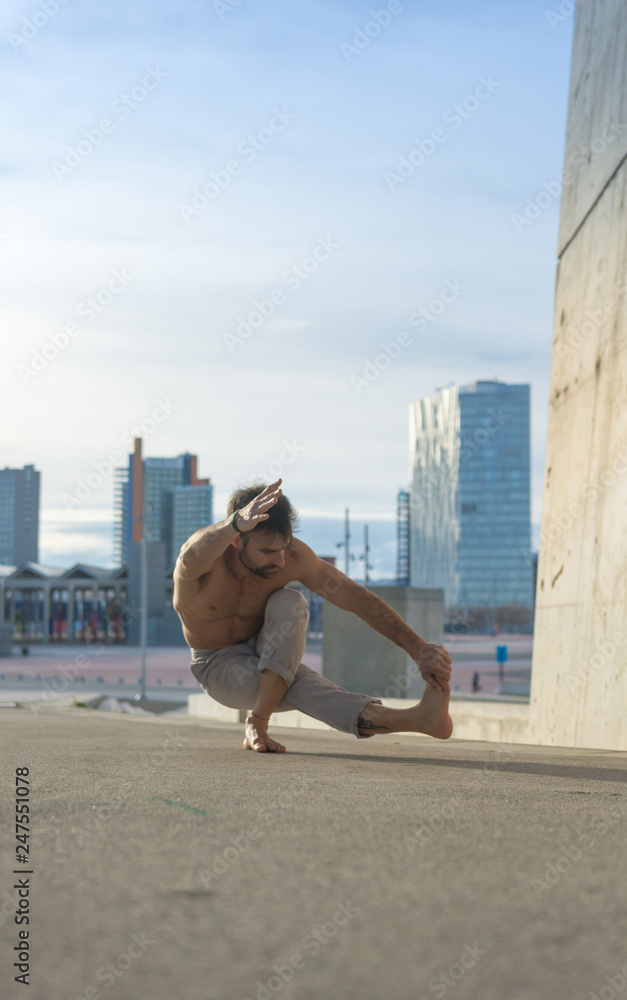 Man performing advanced yoga exercises and stretching. Man performing advanced yoga exercises and stretching.