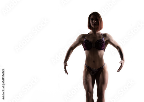 beautiful fitness woman  silhouette of muscular girl poses on white background. female body-building. free space for your text