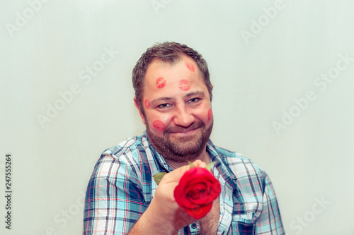 Bearded mature man with a red rose