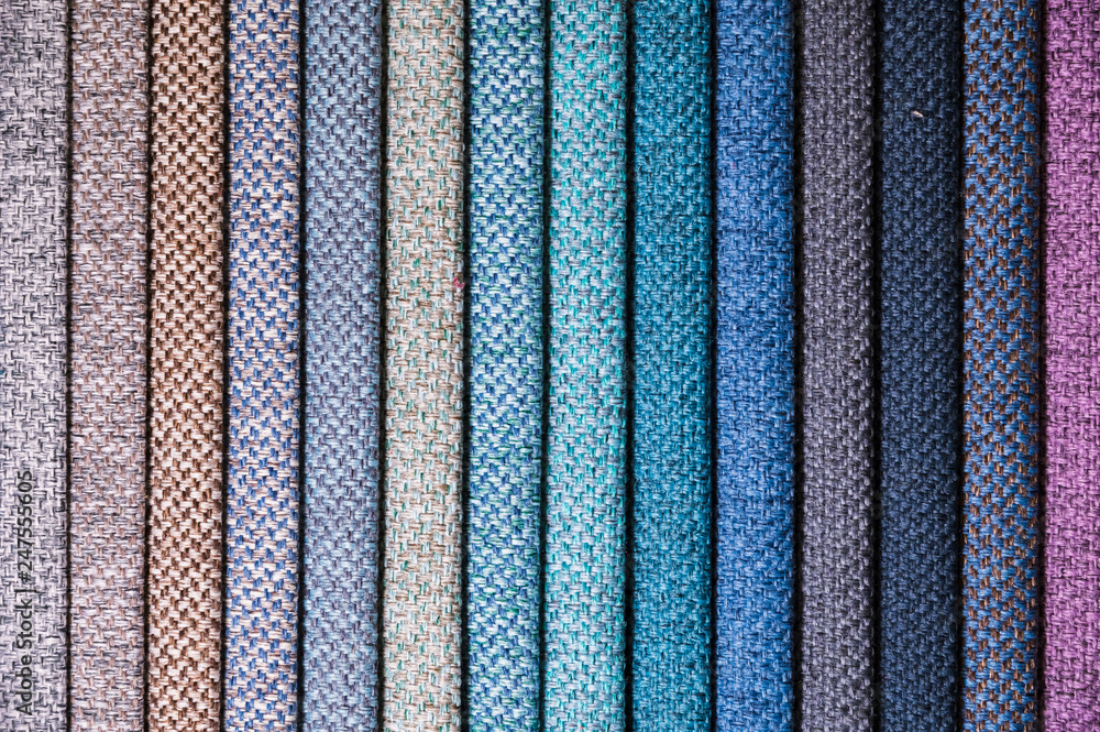 Colorful and bright fabric samples of furniture and clothing upholstery. Close-up of a palette of textile abstract stripes of different colors Colorful and bright fabric samples of furniture and clothing upholstery. Close-up of a palette of textile abstract stripes of different colors