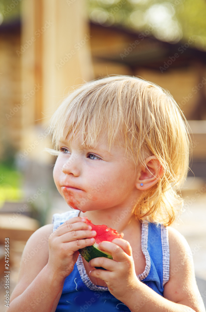 Little cute girl eating watermelon outdoors. Little cute girl eating watermelon outdoors.