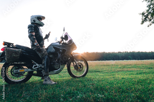 Man stand with tourist motorcycle outdoor sunset  copy space  travel concept  adventurer  active life style
