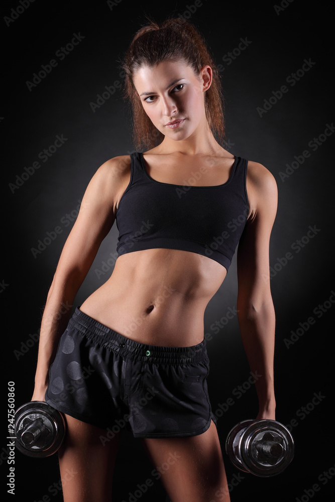 fitness woman in doing exercises with dumbells. fitness woman in doing exercises with dumbells.